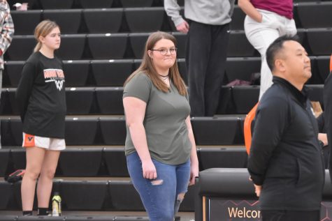 Sophomore Karma Carpenter sings the National Anthem to kick off the girls basketball game