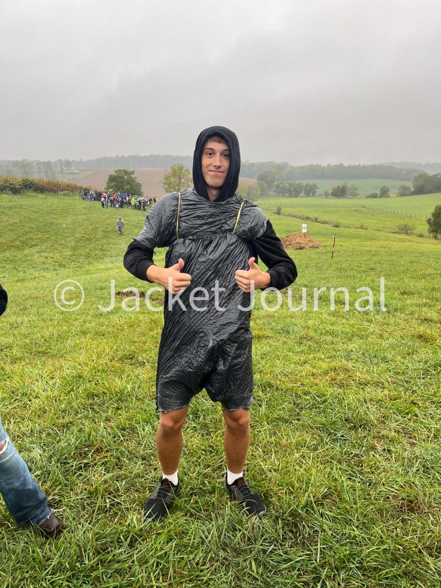 Bryce Hollenback has trash bags on in order for his clothes not get soaked from the rain. 