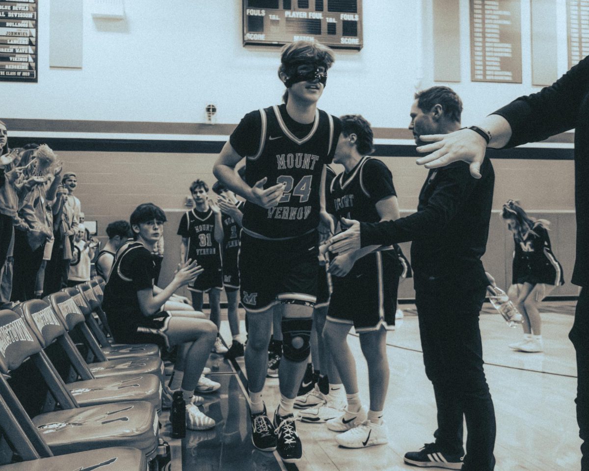 The crowd cheers as junior Trace Beck takes his spot in the starting five.