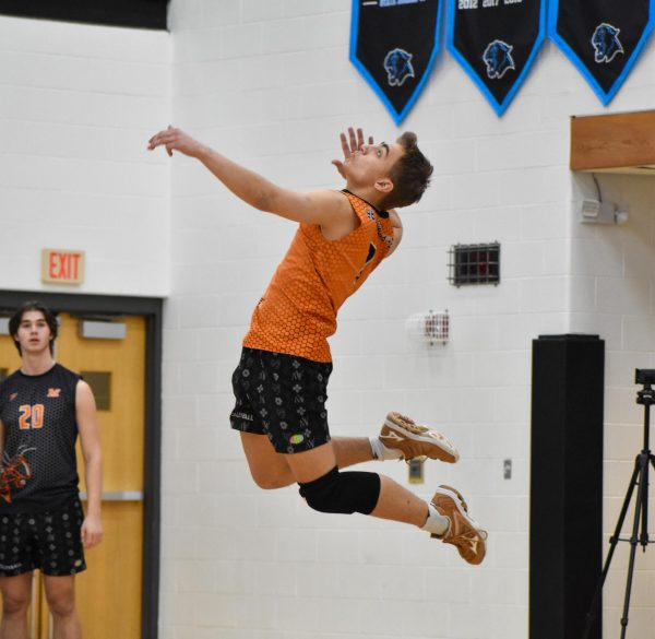 Junior Kirklin Kanuckel goes up for a serve.