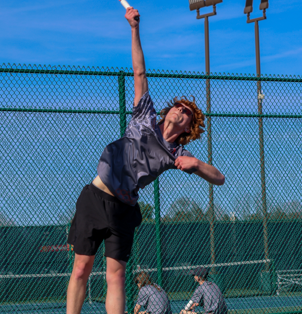 Senior Elijah goes up for a serve against Ontario